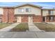 Exterior shot of brick townhomes with stairs leading to front doors and small patios on some units at 8 Greenwood Trail S Dr, Greenwood, IN 46142