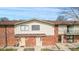 Front exterior of brick townhomes with siding, sidewalks, and stairs leading to front door at 8 Greenwood Trail S Dr, Greenwood, IN 46142