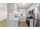 Well-lit kitchen features stainless steel appliances, white cabinets and stone countertops at 8 Greenwood Trail S Dr, Greenwood, IN 46142