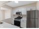 Kitchen features stainless steel appliances, white cabinets, and black hardware at 8 Greenwood Trail S Dr, Greenwood, IN 46142