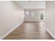 A bright living room features wood-look floors, a window and glass panel doors to a backyard at 8 Greenwood Trail S Dr, Greenwood, IN 46142