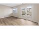 Light filled room with wood-look floors, large glass doors and neutral paint at 8 Greenwood Trail S Dr, Greenwood, IN 46142