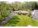 An aerial view of a single story home with a lush lawn and mature trees that enhance the curb appeal at 8808 Manderley Dr, Indianapolis, IN 46240