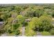 An expansive aerial view showcases the property's serene setting amidst lush greenery and mature trees at 8808 Manderley Dr, Indianapolis, IN 46240