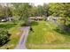 An aerial view of the charming home with lush green lawns, mature trees, and a winding driveway at 8808 Manderley Dr, Indianapolis, IN 46240
