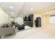 Finished basement featuring black built-in shelves, a couch, and plush rug at 8808 Manderley Dr, Indianapolis, IN 46240