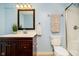 Bathroom with a vanity, sink, and mirror, next to a toilet and standing shower at 8808 Manderley Dr, Indianapolis, IN 46240
