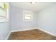 Bedroom featuring a window with blinds and laminate floors at 8808 Manderley Dr, Indianapolis, IN 46240