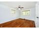 Bedroom with hardwood floors, two windows with blinds, and ceiling fan at 8808 Manderley Dr, Indianapolis, IN 46240