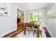 Cozy dining area with a wood table, large window, and an inviting view to the living room at 8808 Manderley Dr, Indianapolis, IN 46240