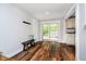 Entryway with bench, wood-look flooring and a sliding glass door to the outdoors at 8808 Manderley Dr, Indianapolis, IN 46240