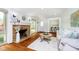 Inviting living room featuring a stone fireplace, hardwood floors, and plenty of natural light at 8808 Manderley Dr, Indianapolis, IN 46240