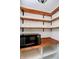 Walk-in pantry with wooden shelving, white shiplap, counter, and microwave at 8808 Manderley Dr, Indianapolis, IN 46240