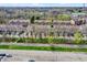 Aerial shot of townhomes near a parking lot, featuring well-maintained landscapes and flowering trees at 918 Rosalind Pl, Carmel, IN 46032