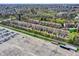 Townhome community aerial view with a large parking lot and colorful spring foliage at 918 Rosalind Pl, Carmel, IN 46032