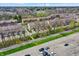 Overhead shot of a community of townhomes with mature trees and a parking area at 918 Rosalind Pl, Carmel, IN 46032