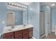 Bathroom featuring double sinks, a dark wood vanity, and a glass-enclosed shower at 918 Rosalind Pl, Carmel, IN 46032