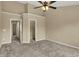 Spacious bedroom featuring neutral walls, plush carpet, a ceiling fan, and a walk-in closet at 918 Rosalind Pl, Carmel, IN 46032