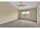 Bedroom featuring neutral walls, carpet flooring, a ceiling fan, and a large window offering natural light at 918 Rosalind Pl, Carmel, IN 46032