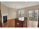 View of dining area with hardwood flooring, center island, fireplace and sliding doors leading to patio area at 918 Rosalind Pl, Carmel, IN 46032