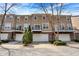 Attractive townhome exterior featuring a one-car garage, balcony, and manicured landscaping at 918 Rosalind Pl, Carmel, IN 46032