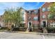 Brick townhome featuring black shutters, landscaped front yard, and well-maintained exterior at 918 Rosalind Pl, Carmel, IN 46032