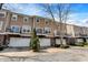 Townhome exterior with brick facade, garage, and balcony overlooking landscaped yard at 918 Rosalind Pl, Carmel, IN 46032