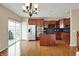View of kitchen featuring stainless steel appliances, cherry wood cabinets, hardwood flooring and a large center island at 918 Rosalind Pl, Carmel, IN 46032