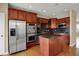 Kitchen showcasing stainless steel appliances, cherry cabinets, granite countertops and center island with hardwood flooring at 918 Rosalind Pl, Carmel, IN 46032