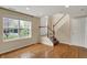 Cozy living room featuring hardwood floors, staircase, and natural light streaming through windows at 918 Rosalind Pl, Carmel, IN 46032