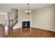 Open living area with hardwood floors, a fireplace, and a staircase at 918 Rosalind Pl, Carmel, IN 46032