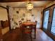 A charming dining room with a wooden table, stone accent wall, and natural light from the adjacent porch at 10960 Marlin Rd, Indianapolis, IN 46239