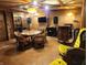 Spacious game room featuring a wood paneled ceiling, vintage lighting, and a large table with seating at 10960 Marlin Rd, Indianapolis, IN 46239