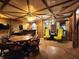 Large game room with a rustic ceiling and stone archway leading to additional seating and bar area at 10960 Marlin Rd, Indianapolis, IN 46239
