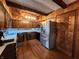 A well-lit kitchen featuring stainless steel appliances, wooden cabinetry, and modern lighting fixtures at 10960 Marlin Rd, Indianapolis, IN 46239