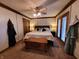 A cozy main bedroom featuring a bed, ceiling fan, and access to a balcony for fresh air at 10960 Marlin Rd, Indianapolis, IN 46239