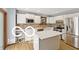 Modern kitchen with white cabinets, an island, stainless steel appliances, and stylish backsplash at 11336 Bloomfield Ct, Indianapolis, IN 46259