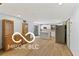 Bright living room showcasing an open floor plan with wood floors and a view to the kitchen at 11336 Bloomfield Ct, Indianapolis, IN 46259