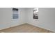 Bright bedroom with two windows, white walls, and light-colored flooring at 1209 N Centennial St, Indianapolis, IN 46222