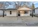 Charming exterior of a home featuring a covered porch and a freshly painted white exterior at 1209 N Centennial St, Indianapolis, IN 46222