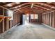 Unfinished garage with wooden rafters and concrete floor at 1209 N Centennial St, Indianapolis, IN 46222