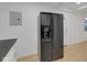 Kitchen area with a stainless steel refrigerator and neutral walls and flooring at 1209 N Centennial St, Indianapolis, IN 46222