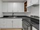 Bright kitchen showcasing white cabinets, dark countertops, and stainless steel oven at 1209 N Centennial St, Indianapolis, IN 46222