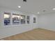Bright interior view of a living space with new flooring and ample natural light through large windows at 1209 N Centennial St, Indianapolis, IN 46222