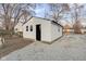 White shed with black door and gray gravel surrounding it at 1209 N Centennial St, Indianapolis, IN 46222