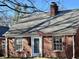 Charming brick home featuring a classic design, a well-maintained roof, and an American flag at 1230 Kessler Blvd E Dr, Indianapolis, IN 46220