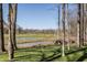 Picturesque backyard view showcasing a pond and golf course framed by mature trees, highlighting outdoor beauty at 1355 Forest Hills Dr, Westfield, IN 46074
