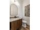 Stylish powder room with modern vanity, designer mirror, and decorative art at 1355 Forest Hills Dr, Westfield, IN 46074