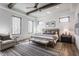 Bright bedroom with tray ceiling, decorative beams, large windows, and stylish furnishings at 1355 Forest Hills Dr, Westfield, IN 46074