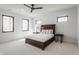 Spacious bedroom featuring a tray ceiling, large windows, and plush carpeting at 1355 Forest Hills Dr, Westfield, IN 46074